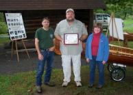 FRED KUEPPER, center, received a Tourism Ambassador Award at the Salmon River Fish Hatchery open house in Altmar in recognition of his contributions to Project Healing Waters, fishing education and conservation projects in Oswego County. Looking on are Salmon River Program Coordinator Fran Verdoliva and Janet Clerkin, Tourism and Public Information Coordinator for the Oswego County Department of Community Development, Tourism and Planning.