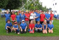 TOURISM AMBASSADORS – The Bridgehouse Brats surround their founder, Cathy Lee, and AmeriCorps member Anthony Furco at the Phoenix Bridgehouse. The group was presented the Oswego County Tourism Ambassador Award by the County Tourism Advisory Council.