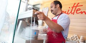 smitten ice cream being made by an employee in a red apron