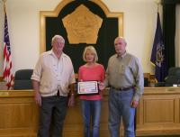 NANEEN AND RICHARD DROSSE receive a Tourism Ambassador Award from Edwin Lighthall (left), chairman of the Oswego County Tourism Advisory Council. They have organized water chestnut removal projects, Earth Day cleanups, Great Bear Farm trail expansion, and community events in Minetto for several years.
