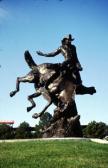 Bronze statue of a cowboy being bucked off by a bronco