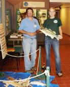 Children of all ages will be able to take part in a variety of activities at the DEC’s open house at the Salmon River Fish Hatchery in Altmar. Pictured are DEC aquatic biologist Jim Everard and Oswego County Public Information Officer Jessica Burt at last year’s open house. Burt correctly identified a largemouth bass in the DEC’s fish identification game.