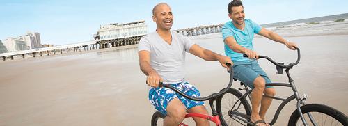 A couple of men enjoy a bicycle ride on the hard-packed sands of Daytona Beach