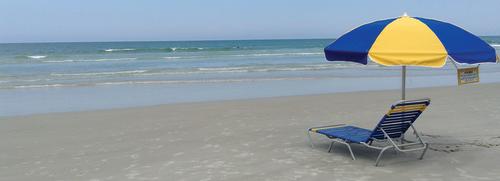 Rent an umbrella chair for a day and relax on Daytona Beach