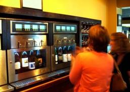Patrons try out the new wine vending machines at Corks & More in Ithaca, where customers can dispense their own wine via vending machines.