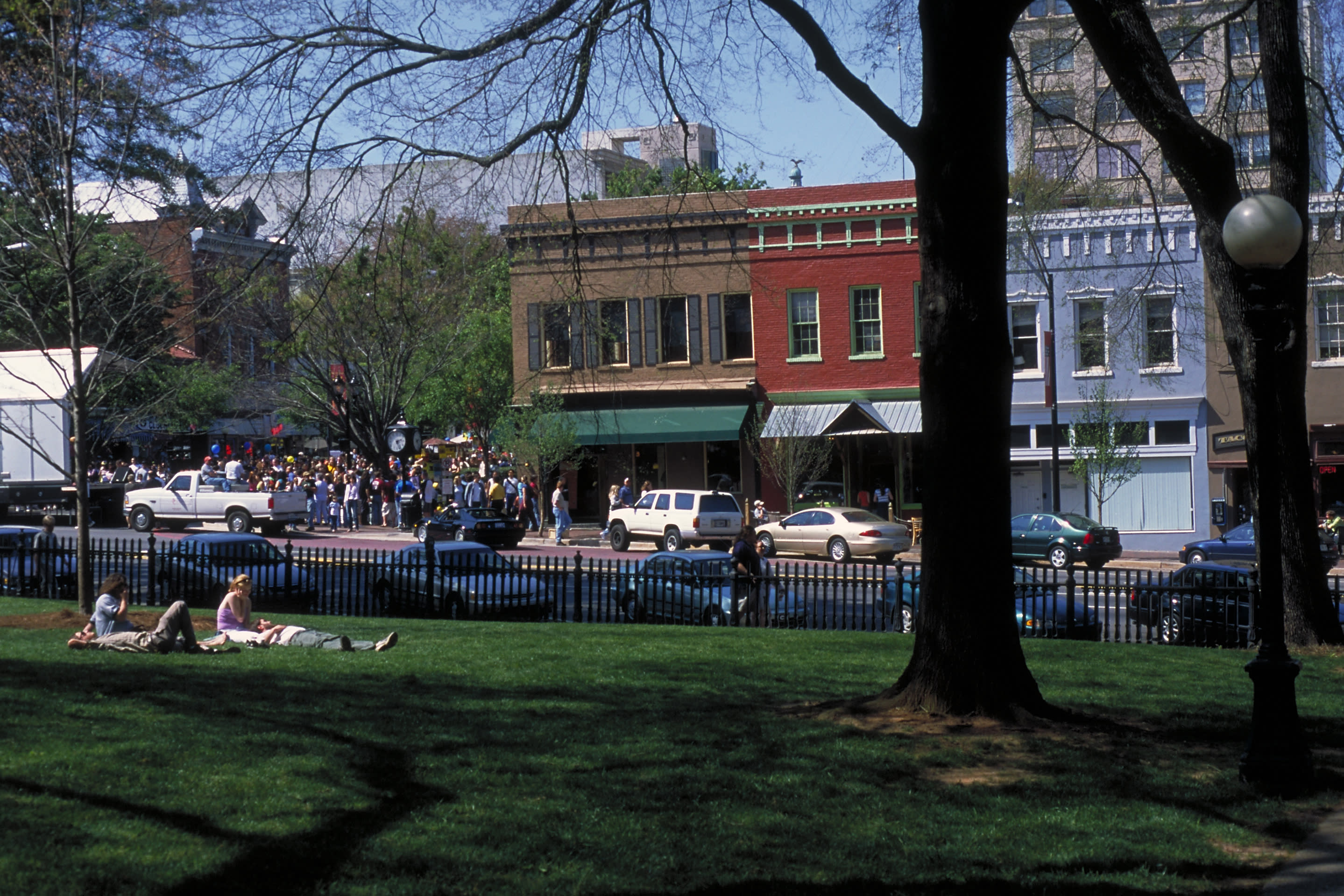 Undedrgrads sitting on a grassy area of UGA North Campus near Downtown Athens