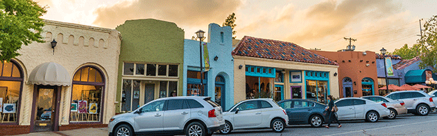 Cars parked in front of colorful row of buildings within Oklahoma City's Paseo Arts District