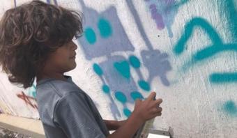 Rensselaer Public Art Walk - kid spray painting