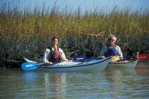 Couple Kayaking near saltmarsh grass at Carolina State Beach Park