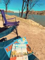 Kansas Travel Guides in a folding chair at Lake Scott State Park