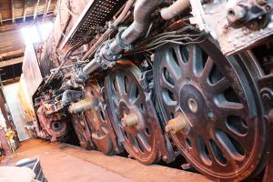 A close-up photo of the wheels of a steam train.