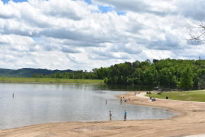 People On The Shore Of Deam Lake Beach