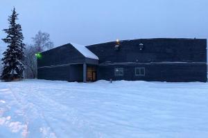 panoramic exterior of a dark two-story building in winter