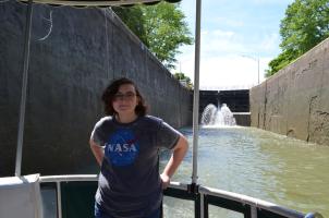 Girl stands on Sam Patch Tour Boat in a lock on the Erie Canal