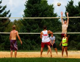 A group playing sand volleyball in Howard County, MD