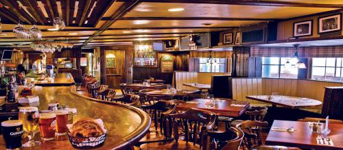 The interior of the restaurant Alchemist and Barrister, with a long winding bar and pub style seating