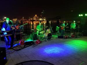 Band Playing In Front Of Colorfully Lit Dance Floor