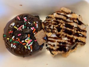 Chocolate and sprinkle donut and s'mores donut in box together from Donna's Delicious Dozen