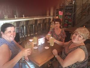 In front, from left, Cheryl Eggelston and Peggy Howey, both of Fort Wayne, propose a birthday toast to Marcia Hoffman, in back, at the Kekionga Cider Company on Maysville Road.