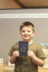 Nathan Walker, Herman Avenue Elementary, gets his ‘Passport to History’ stamped at the Cayuga County Office of Tourism