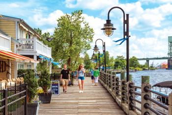 Couple walking on the Wilmington Riverwalk near restaurants