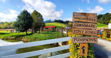 sign reading wagon rides corn maze pony rides pumpkins at neltner farm in cambell county kentucky