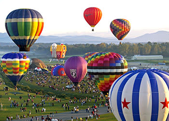 Hot air balloons above the crowds at Adirondack Balloon Festival
