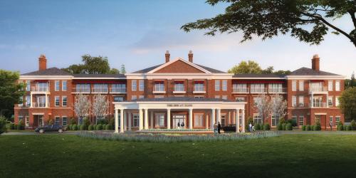 Red brick building with green lawn and blue sky behind