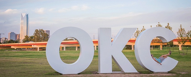 OKC sign in front of Oklahoma City skyline
