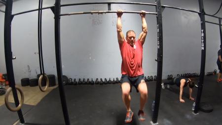 CrossFit athlete performing bar exercises.