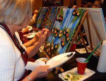 Lady painting oranges