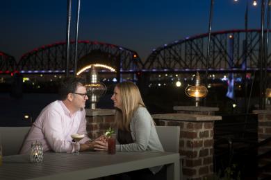 Couple Sitting At Table And Looking At Each Other In Portage House