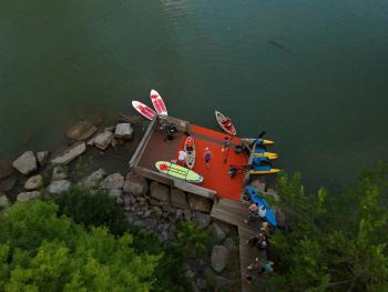 Visitors prepare to head out and explore in kayaks on a warm summer day