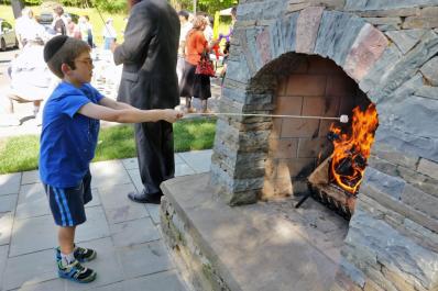 Boy roasting marshmallow at Jewish Discovery Center