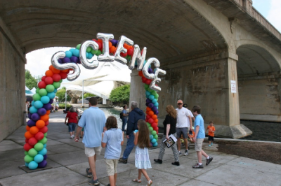 A family walks through a balloon arch that says SCIENCE in Knoxville, TN