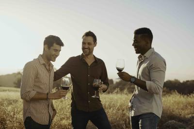 Three men drinking glasses of red wine