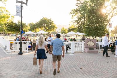 Couple holding hands while walking in Paso Robles