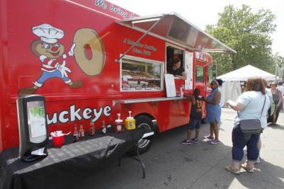 People lined up to order from Buckeye Donuts food truck
