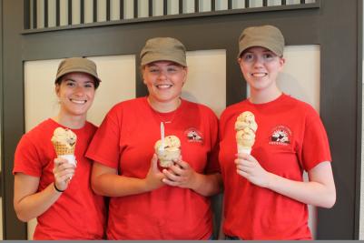 Three employees pose with ice cream cones at the Cheshire Farms Creamery