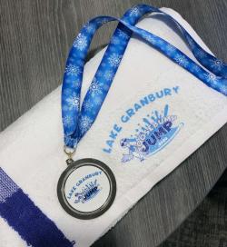 White towl and medal with Goosebump Jump logo