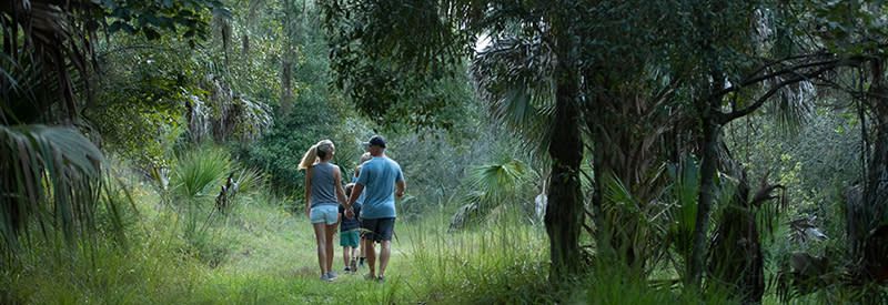 A family hikes along a trail