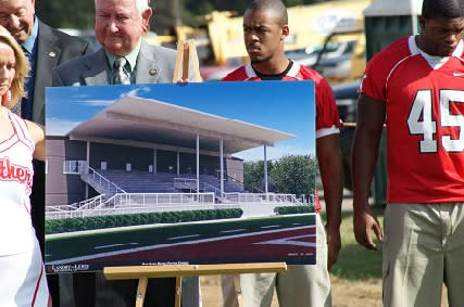 Players and administrators hold a picture of the new Petal Middle School Stadium built by Southern Bleacher.