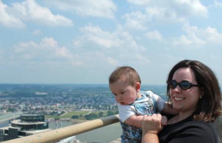 mom with baby looking at cincinnati from atop the carew tower observation deck