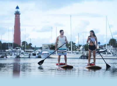 Paddleboarding Couple by Lighthouse