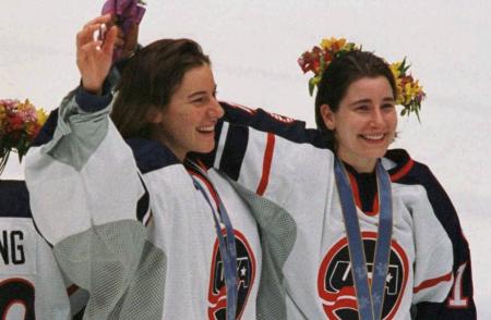 Sara DeCosta celebrating team USA women's hockey medal with teammate