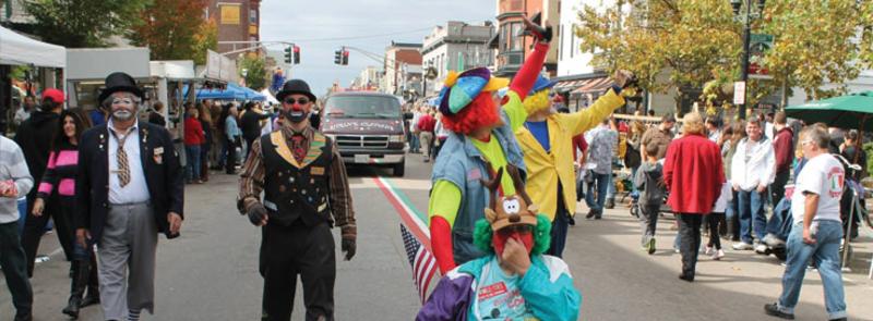 Clowns wave at the Annual Federal Hill Columbus Day Parade