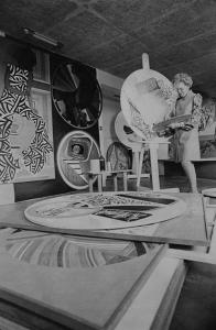 Black and white photo of Eve Drewelowe working on her artwork