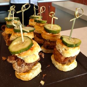 Mini slider burgers topped with pickle garnish at Taste of Dine Originals