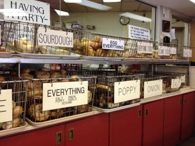Shelf stocked with baskets full of various flavors of bagels at Blocks Bagels