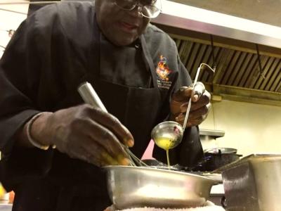 Chef cooking sauce in kitchen of Creole Kitchen restaurant